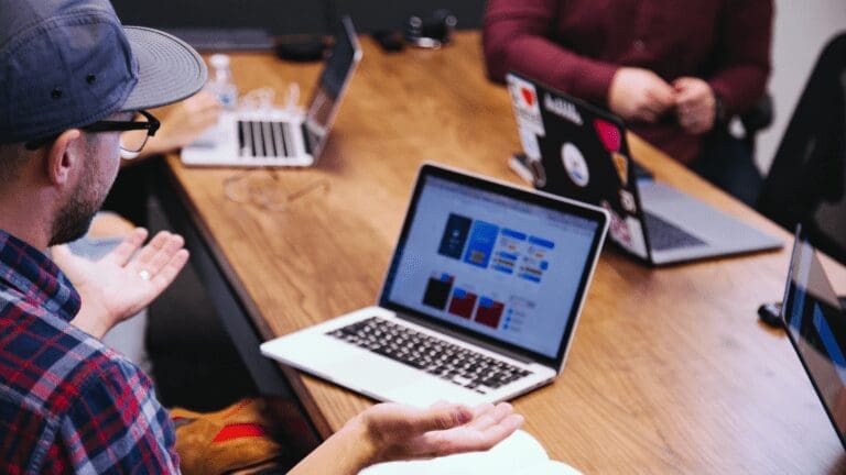 Guy Explaining With the Laptop on the Table